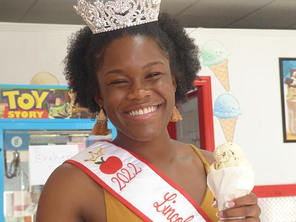 <span style="font-size: small;"><strong>Anaia enjoys a cone of cookie dough <br />ice cream at Scoops by the Square.</strong></span>