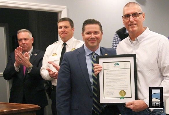 At a recent meeting of the Stanley Town Council, Mayor Steven Denton presented retired officer Robert Carrigan of the Stanley Police Department with a proclamation in his honor. In the background are town manager Heath Jenkins and Stanley Police Department Chief Derek Summey.