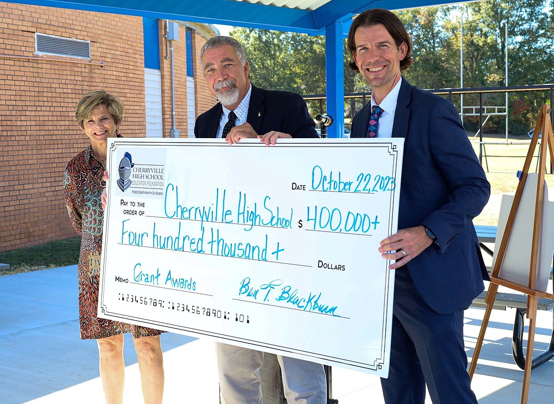 A check from the Cherryville High School Education Foundation signifies more than $400,000 in contributions to the school.  Pictured are Foundation representatives Susie Lewis (chairman) and Ben Blackburn with principal Shawn Hubers.