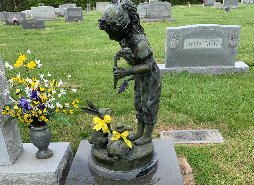 Bronze statue of a little girl feeding rabbits is valued at $3,000.